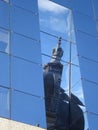 Dome of old style historical building, reflected on glass wall of modern building Royalty Free Stock Photo